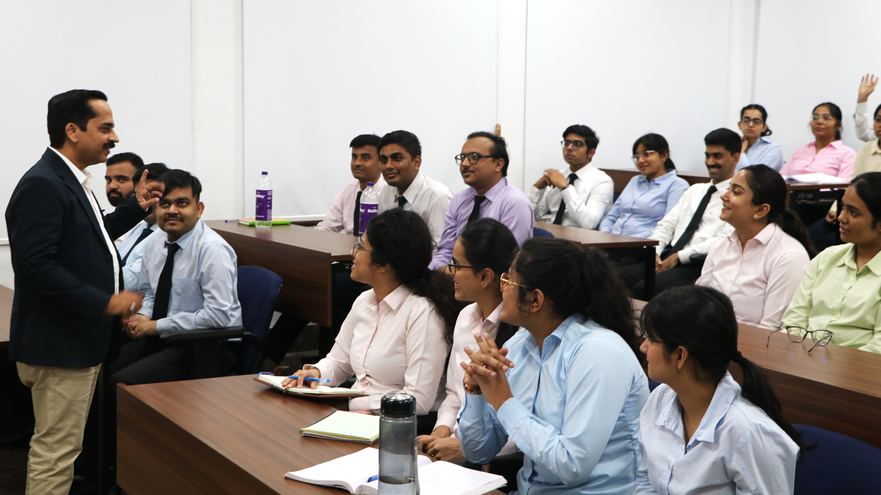 Dr. Ashish Pruthi speaking with participants during an IMT Ghaziabad session
